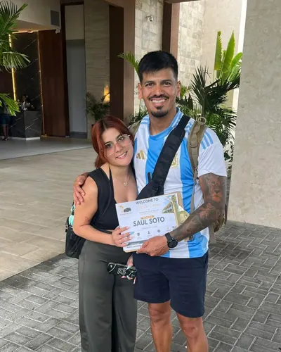 Couple at their hotel entrance with their welcome sign