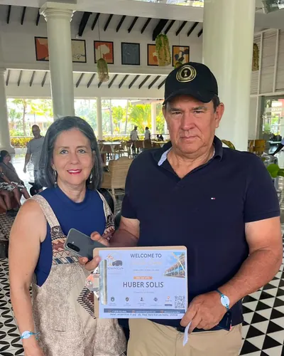 Couple in their hotel lobby with their welcome sign